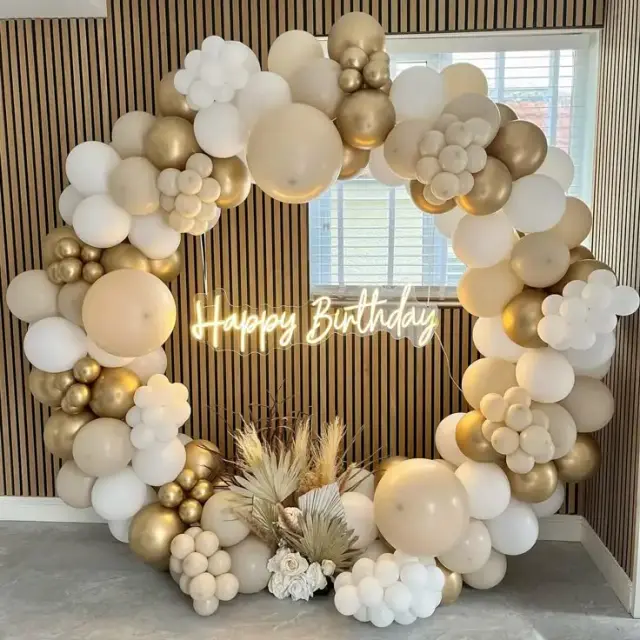 Elegant birthday décor with balloons and cake table